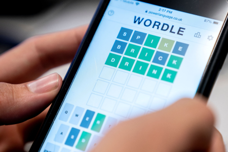 person playing wordle phone