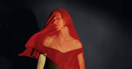 woman under red veil 1200 628 facebook