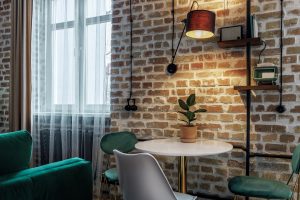 apartment space brick walls green chairs