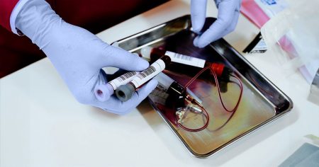 scientist handling blood vials 1200 628 facebook