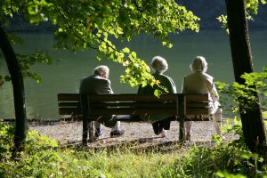 senior citizens sat park bench